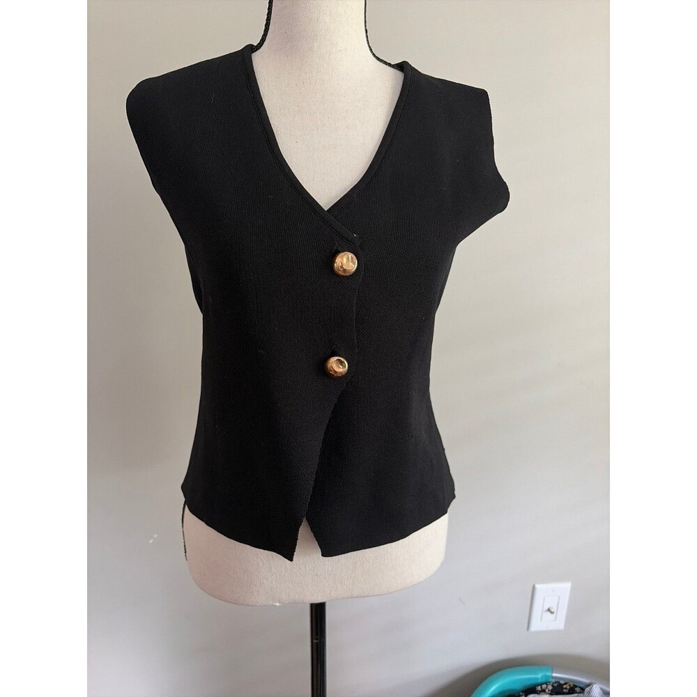 Black vest with gold tone buttons. Small